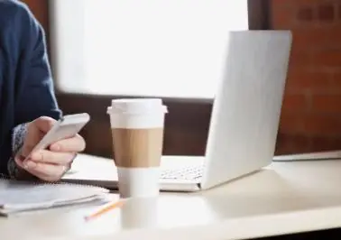 Laptop with coffee cup